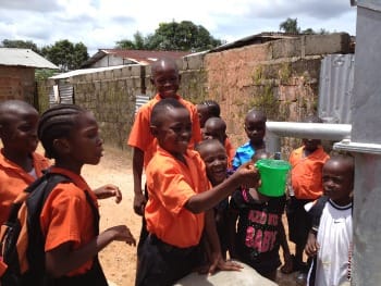 Photo of Liberian children getting water from a new well.