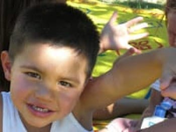 Photo of smiling little boy playing outside.