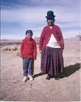 Photo of little girl and her grandmother in the empty-looking landscape of the Bolivian altiplano.