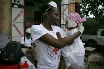 image of Red Cross volunteer holding a wounded child