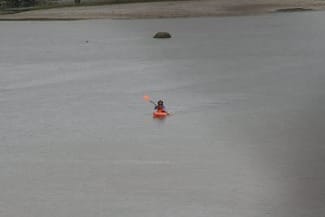 Photo of author paddling kayak in river