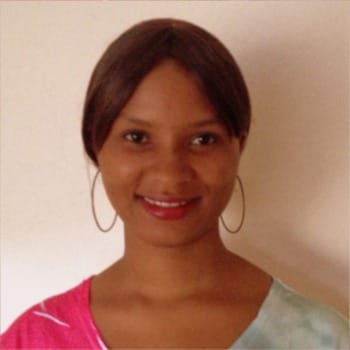 Photo of the smiling face of a young Sierra Leonean woman.